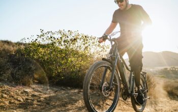 a man riding a bike down a dirt road